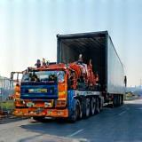 Equipment being loaded onto transport truck